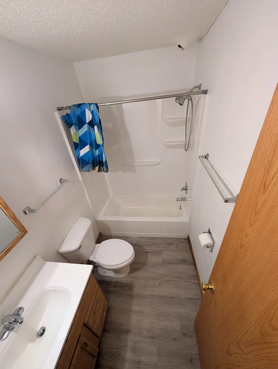 Bathroom after a thorough deep cleaning of the stained bathtub and dirty floors in Fargo, ND