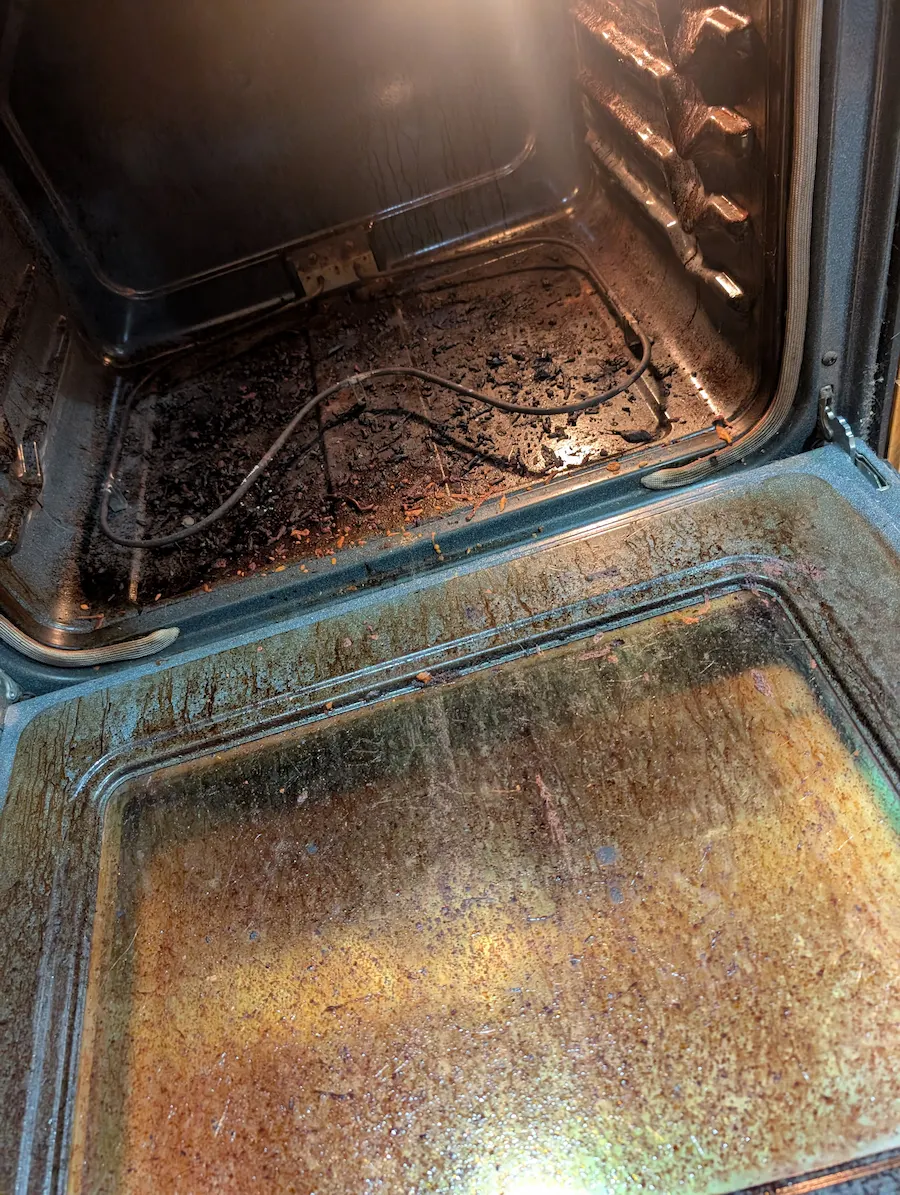 Dirty oven interior with built-up grease and baked-on grime before deep cleaning in Fargo, ND