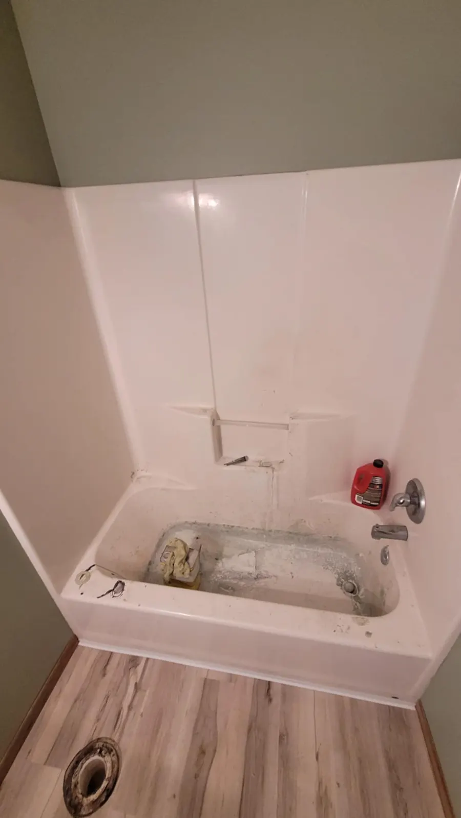 Bathtub and shower walls with heavy dirt buildup, grime, and stubborn staining before deep cleaning in Fargo, ND