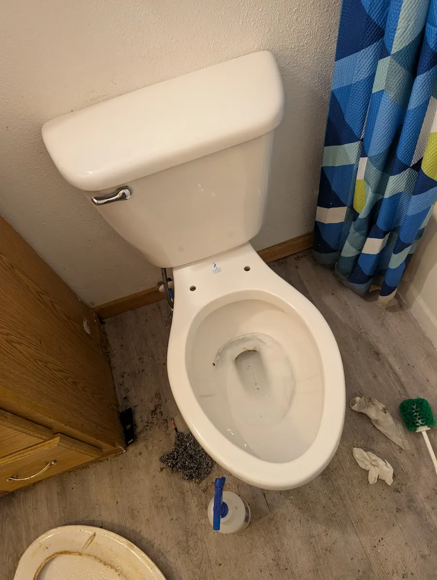 Toilet bowl during a deep cleaning in Fargo, ND, showing progress removing stubborn stains and years of buildup